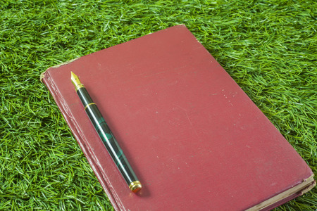 Vintage Fountain Pen on old book backgroundの写真素材