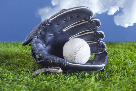 Baseball in a Glove in the Outfieldの写真素材