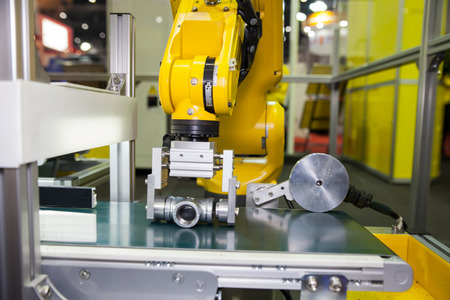 BANGKOK - SEPTEMBER 22 :Robotic arm on work  display at METALEX 2014 on Nov 22,2014 in BITEC ,Bangkok, Thailand.のeditorial素材