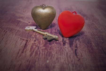 Key for open your Red heart on the wooden background.の写真素材