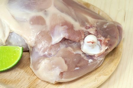 chicken drumsticks on wood backgroundの写真素材