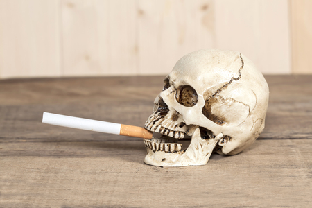Smoking human skull with cigaretteの写真素材