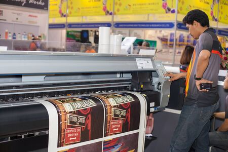 BANGKOK ,THAILAND - JULY 11: Unidentified people check with digital textile printer at Garment Manufacturers Sourcing Expo 2015 (GFT 2015) , on JULY 11, 2015 in Bangkok, Thailand.のeditorial素材