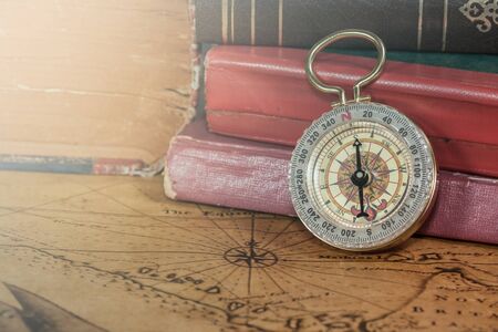 Vintage compass lies on an ancient mapの写真素材