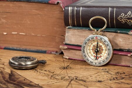 Vintage compass lies on an ancient mapの写真素材