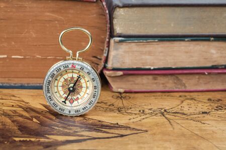 Vintage compass lies on an ancient mapの写真素材