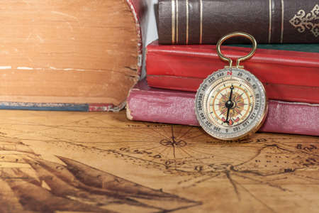 Vintage compass lies on an ancient mapの写真素材