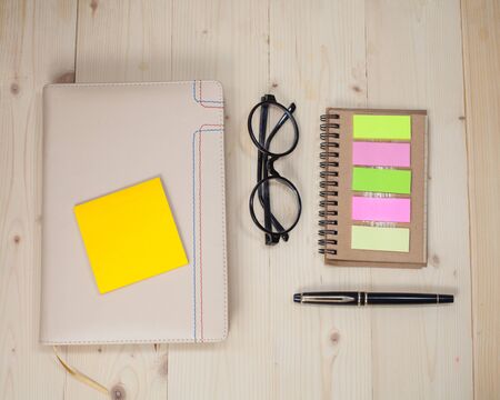 book note with post it on wood backgroundの写真素材