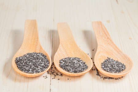 chia seeds in  wooden spoon on wood tableの写真素材