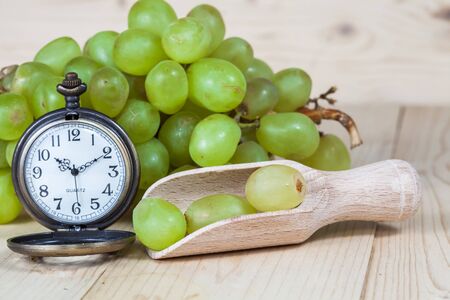 green grape and old pocket clockの写真素材
