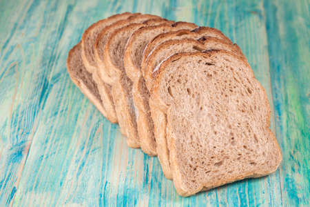 Slices of rye bread  on wood background ,vintage tone