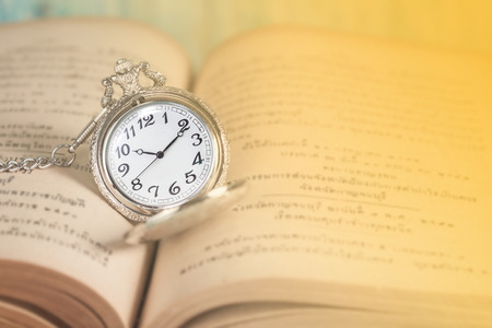 vintage pocket clock and old books