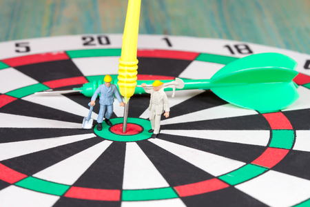 Miniature worker work on darts,selective focusの写真素材