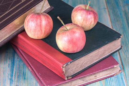 Red apple on old bookの写真素材