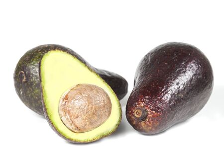 Whole and half avocado isolated on white.