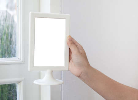 woman hand holding a blank menu frame