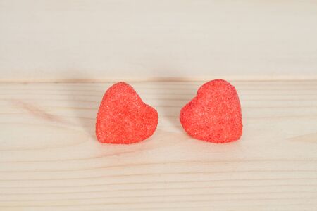 heart candies coated with sugar sitting on wood.selective focus.の写真素材