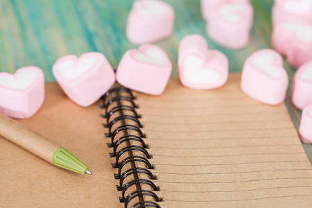 recycle note book and pen with sweet heart shape on 
wooden background,valentine day concept.の写真素材