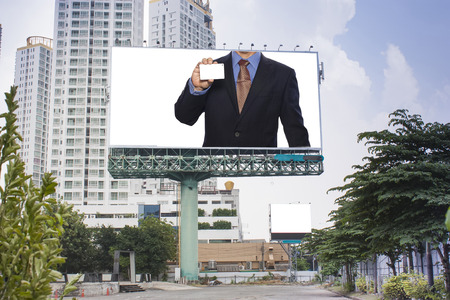 Advertisement business man holding a credit card on billboard.の写真素材