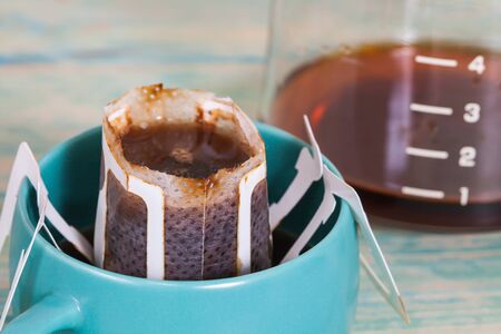 Drip bag fresh coffee in cupの写真素材