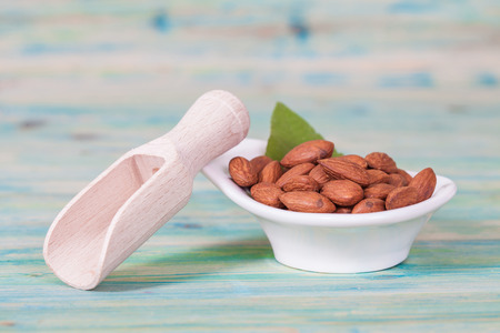 Almonds in bowl on woodの写真素材