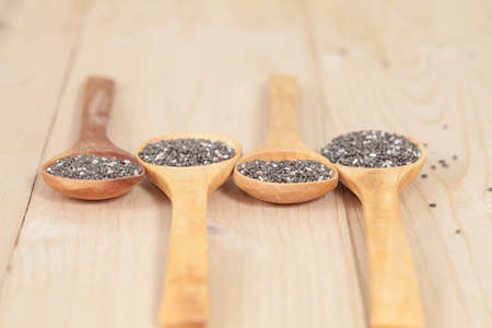 Nutritious chia seeds on a wooden spoonの写真素材