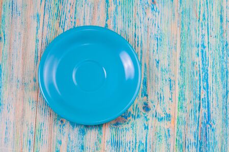 Empty plate on blue wooden background. Top view with copy spaceの写真素材