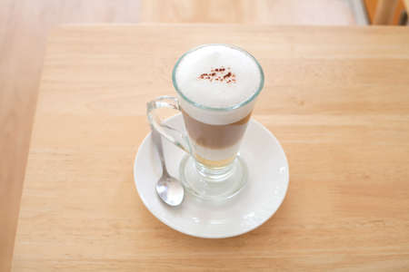 Cup of Hot  Latte Coffee on wood tableの写真素材