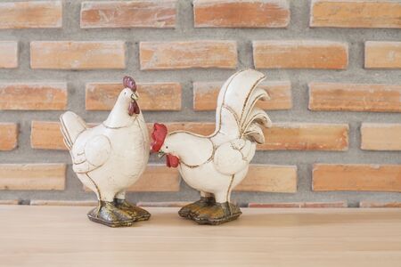 ancient  cock toy on woodの写真素材