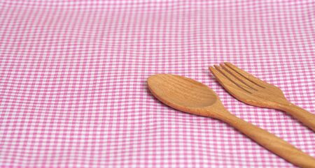 Color tablecloth, spoon, fork on  table backgroundの写真素材
