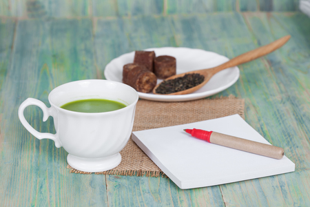 green tea with milk or hot matcha latte with paper 
note on woodの写真素材