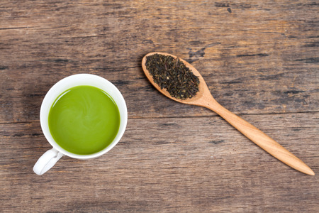 green tea with milk or hot matcha latte with paper 
note on wood .の写真素材