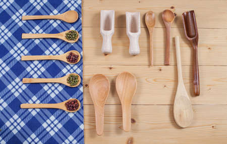 Wooden kitchen utensil on tablecloth background
