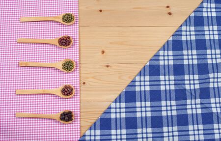 Tablecloth, wooden spoon, on wood textured backgroundの写真素材