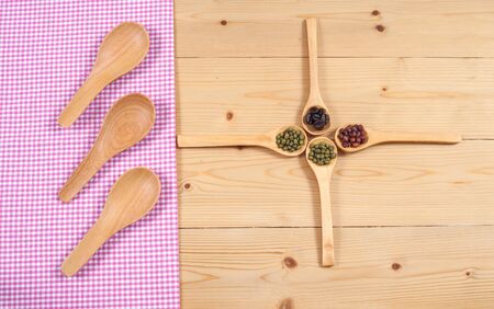 Tablecloth, wooden spoon, on wood textured background