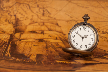 Pocket watch on old map background, vintage style light and toneの写真素材