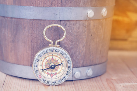 Classic Compass on a Wooden Table. Blank Wood 
Texture Background. Copy Space for Text or Imageの写真素材