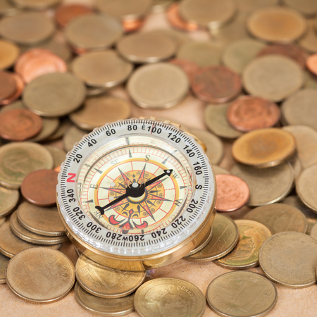 navigation compass with  coins money  , financial 
conceptの写真素材