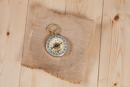 top view of compass on burlap canvas fabric background. explorer andの写真素材