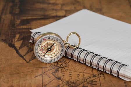 Compass with note book on old map vintage process styleの写真素材