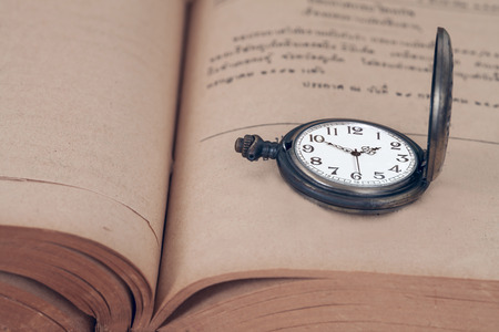 Vintage pocket watch on old books.の写真素材