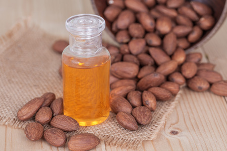 almond oil and  almonds seed on wooden backgroundの写真素材