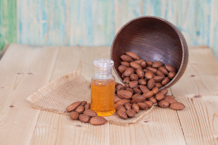almond oil and  almonds seed on wooden backgroundの写真素材