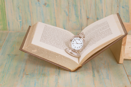 Pocket Watch over Age Book Background ,Time 
Conceptの写真素材