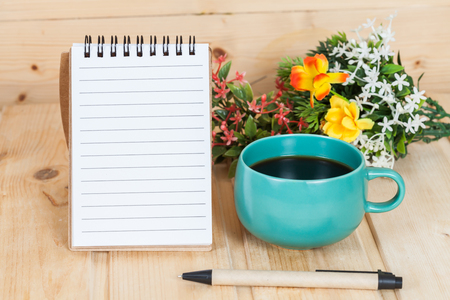 note book  and pen on wood tableの写真素材