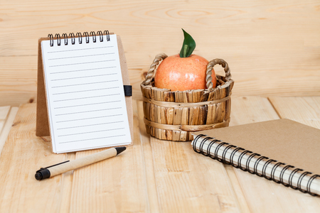 note book  and pen on wood tableの写真素材