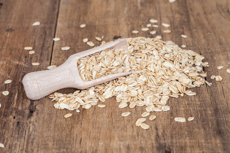 oats in spoon on wood tableの写真素材