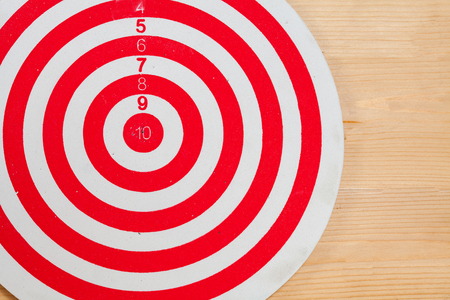 dart arrow and dartboard on wood backgroundの写真素材