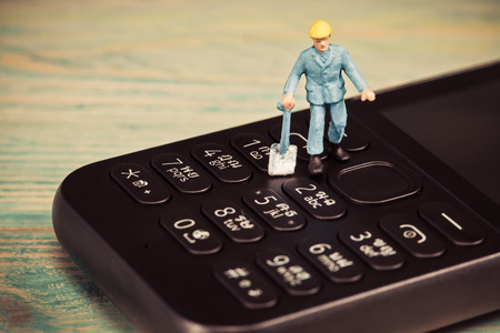 Miniature people working on mobile ,selective focusの写真素材
