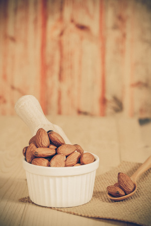 Almonds in bowl  on woodの写真素材